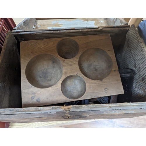 285 - A domed trunk containing flat irons, elm cash-tray etc