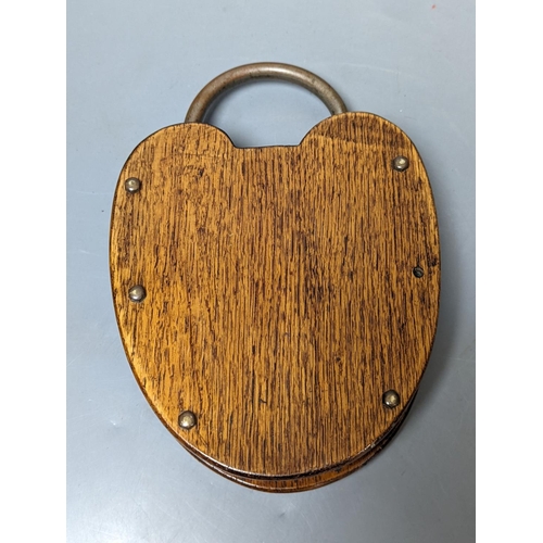 289 - An unusual oak padlock-shaped cribbage board 22cm