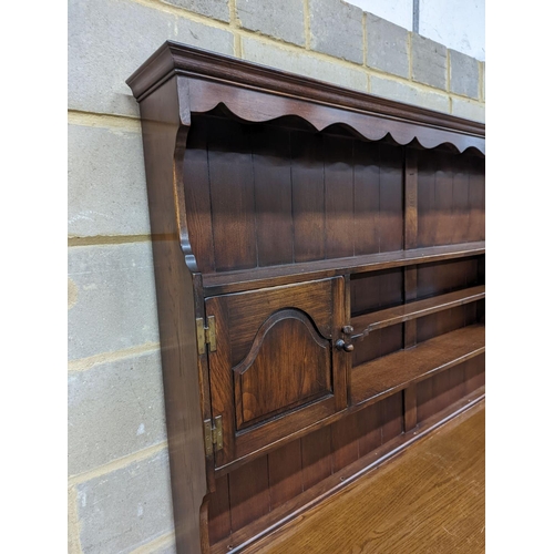 29 - A Georgian style oak dresser base with boarded rack, W-184cm, D-46cm, H-188cm.