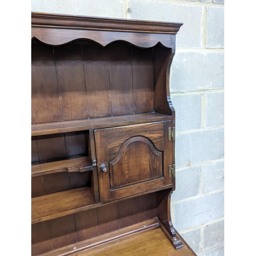 29 - A Georgian style oak dresser base with boarded rack, W-184cm, D-46cm, H-188cm.