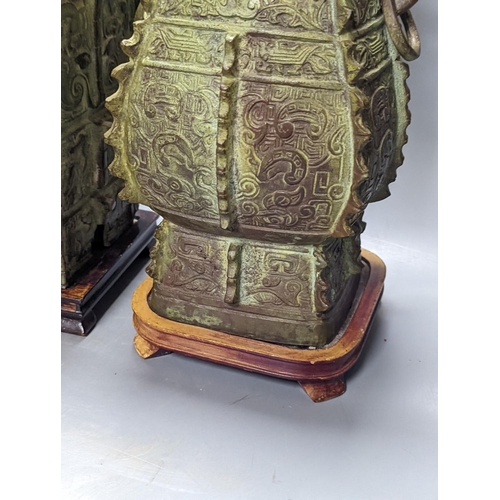 310 - Two Chinese archaic style bronze lamp bases, 38 cm high to top of fitting