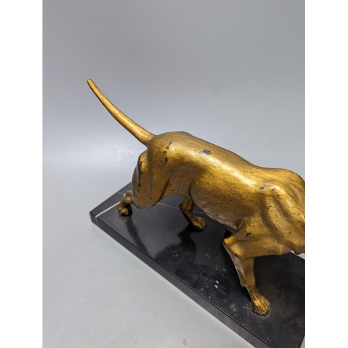 327 - A gilt-metal model of a pointer on marble base 29cm