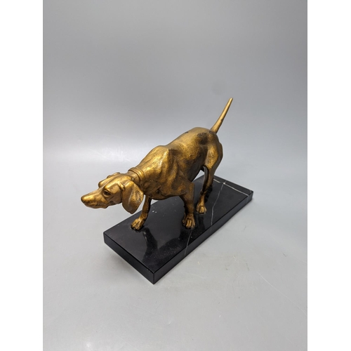 327 - A gilt-metal model of a pointer on marble base 29cm