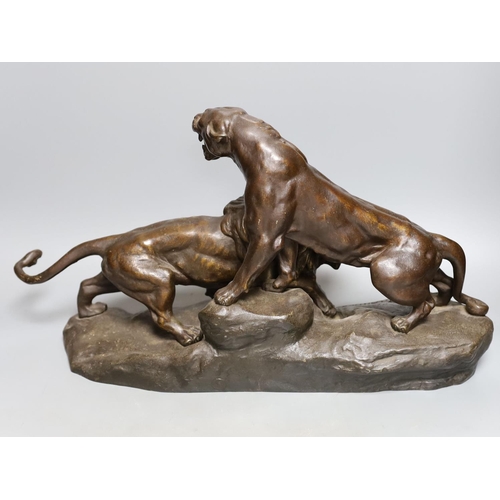 398 - A  patinated spelter group of a lion and lioness, 53 cms wide.