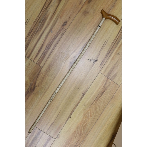 408 - A vertibrae walking cane, 90 cms.