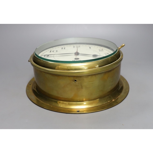 421 - A Mercer brass bulkhead timepiece, 25 cms wide.