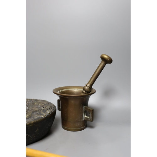 422 - Two pestles and mortars and a Chinese gong with beater, gong 21 cms wide.