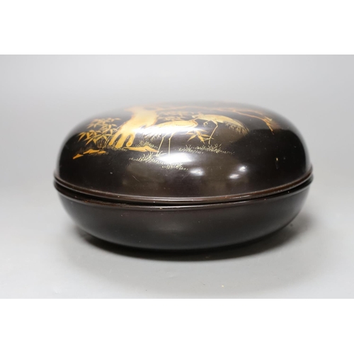 428 - A Japanese lacquer box and cover, 21 cms diameter.