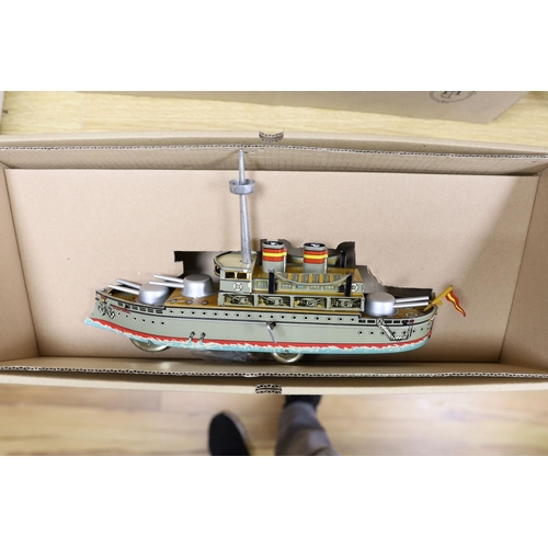 437 - Three IBA tinplate boxed toys, two boats and a train,largest boat 42 cms wide.