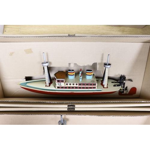 437 - Three IBA tinplate boxed toys, two boats and a train,largest boat 42 cms wide.