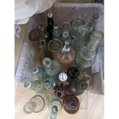 450 - A large collection of antique glass bottles and jars