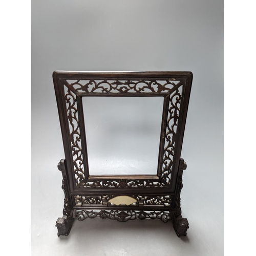 485 - A Chinese hardwood carved table screen, frame and stand, 30 cms high.