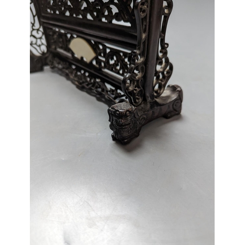 485 - A Chinese hardwood carved table screen, frame and stand, 30 cms high.