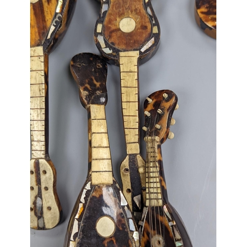 507 - Five 19th century tortoiseshell miniature stringed instruments, longest 20cm.