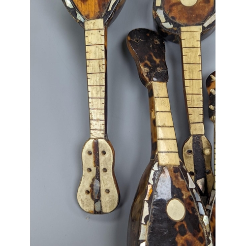 507 - Five 19th century tortoiseshell miniature stringed instruments, longest 20cm.