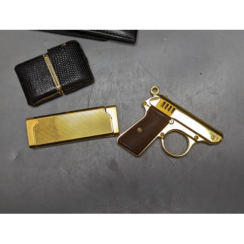 514 - Dunhill and other wallets, novelty pistol lighter, etc.