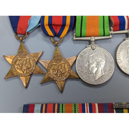 522 - A WWII medal group of six, with miniatures, and a royal commemorative medal, 1937