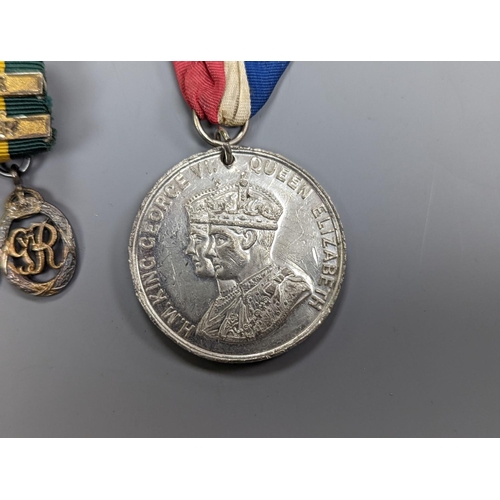 522 - A WWII medal group of six, with miniatures, and a royal commemorative medal, 1937