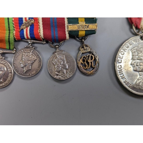 522 - A WWII medal group of six, with miniatures, and a royal commemorative medal, 1937