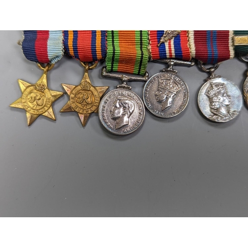 522 - A WWII medal group of six, with miniatures, and a royal commemorative medal, 1937