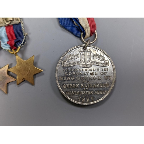 522 - A WWII medal group of six, with miniatures, and a royal commemorative medal, 1937