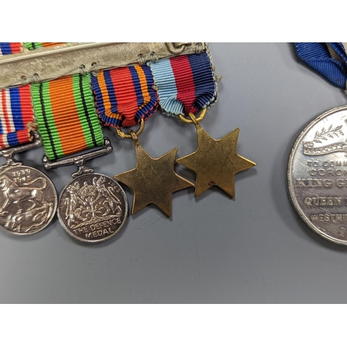 522 - A WWII medal group of six, with miniatures, and a royal commemorative medal, 1937