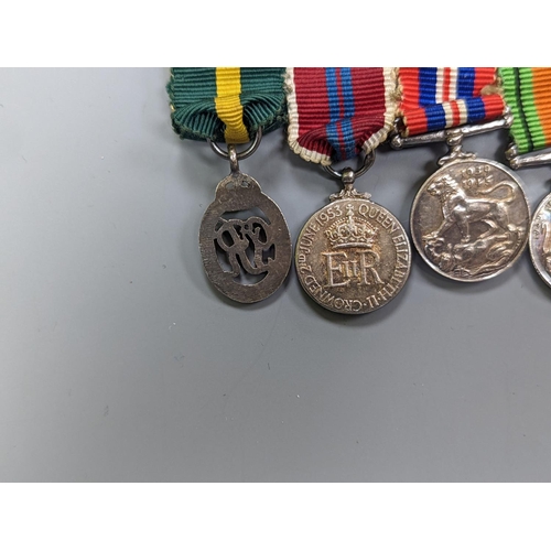 522 - A WWII medal group of six, with miniatures, and a royal commemorative medal, 1937