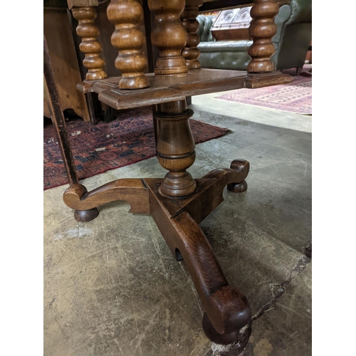 54 - An early 20th century circular oak tripod book table, diameter 60cm, height 69cm