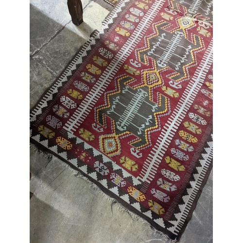 57 - A Kilim polychrome flatweave runner, 380 x 118cm (holed)