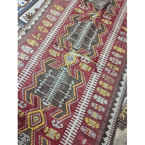 57 - A Kilim polychrome flatweave runner, 380 x 118cm (holed)