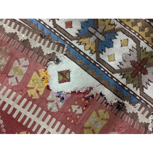 57 - A Kilim polychrome flatweave runner, 380 x 118cm (holed)