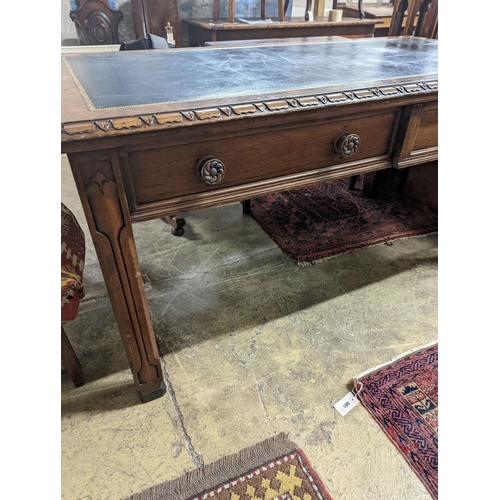 59 - A Victorian Gothic style walnut two drawer library table, width 152cm, depth 78cm, height 76cm... 