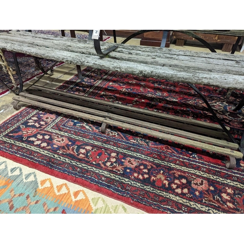 71 - A 19th century wrought iron slatted garden bench with footrest, bench length 182cm, depth 45cm, heig... 