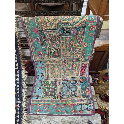 72 - A Kelim flatweave rug, an Indian fabric panel and a saddle bag