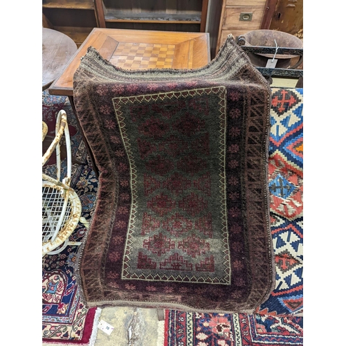 72 - A Kelim flatweave rug, an Indian fabric panel and a saddle bag