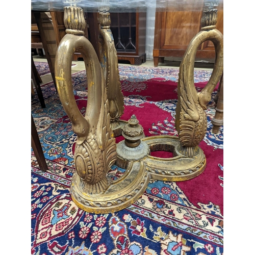 73 - A pair of Empire style circular glass top gilt composition ‘swan’ occasional tables. D-69cm, H-55cm.... 