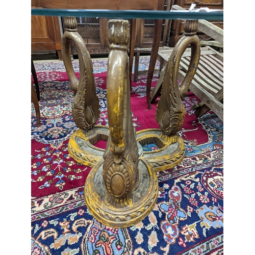 73 - A pair of Empire style circular glass top gilt composition ‘swan’ occasional tables. D-69cm, H-55cm.... 