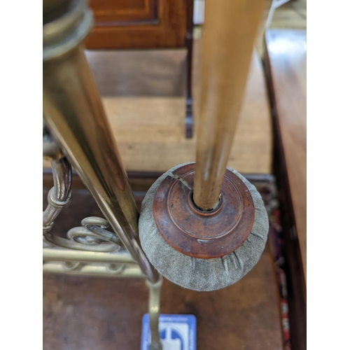 75 - An Edwardian brass dinner gong with striker, width 50cm, height 84cm