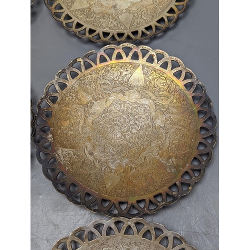 803 - A set of six Persian white metal circular shallow dishes, with pierced borders, 16.3cm, 972 grams.... 