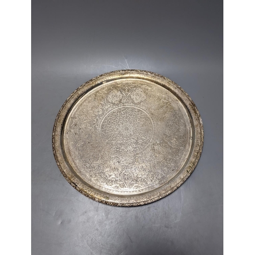 807 - A Persian engraved white metal circular drink's tray by Vartan, 32cm, 747 grams and a white metal wa... 