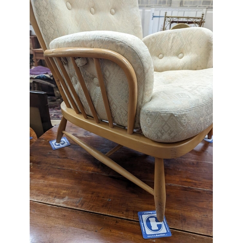 82 - An Ercol Jubilee beech armchair with loose cushion upholstery, width 77cm, depth 80cm, height 86cm... 