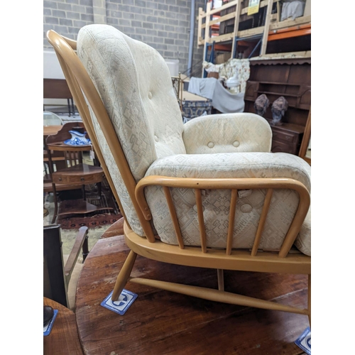 82 - An Ercol Jubilee beech armchair with loose cushion upholstery, width 77cm, depth 80cm, height 86cm... 