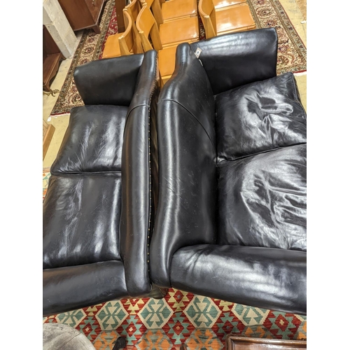 88 - A pair of black leather scroll arm two seater settees on flat bun feet, length 184cm, depth 80cm, he... 