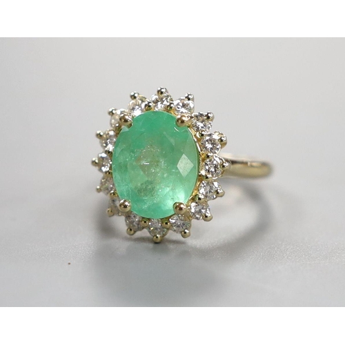 884 - A modern 14k yellow metal, emerald and diamond set oval cluster ring, size M, gross weight 5.9 grams... 