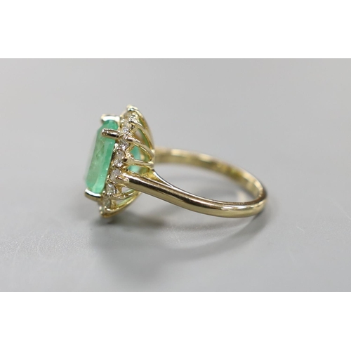 884 - A modern 14k yellow metal, emerald and diamond set oval cluster ring, size M, gross weight 5.9 grams... 