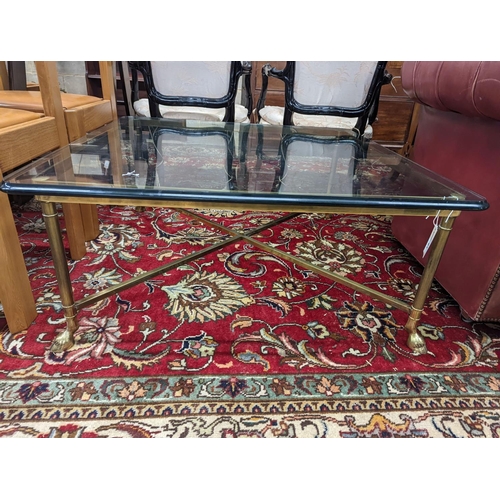 91 - A Maison Jansen style square glass top brass coffee table on hoof feet, width 95cm, height 40cm... 