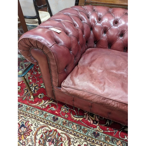 92 - A Victorian style buttoned burgundy leather Chesterfield settee, length 172cm, depth 90cm, height 73... 