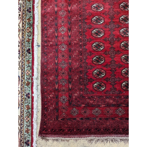 96 - A Bokhara burgundy ground rug, 190 x 130cm