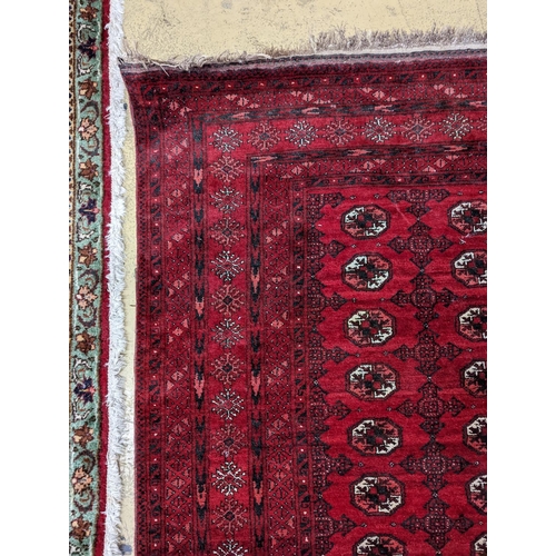 96 - A Bokhara burgundy ground rug, 190 x 130cm