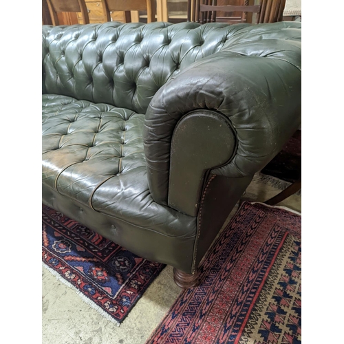 97 - A late Victorian buttoned green leather Chesterfield settee, length 184cm, depth 82cm, height 70cm... 